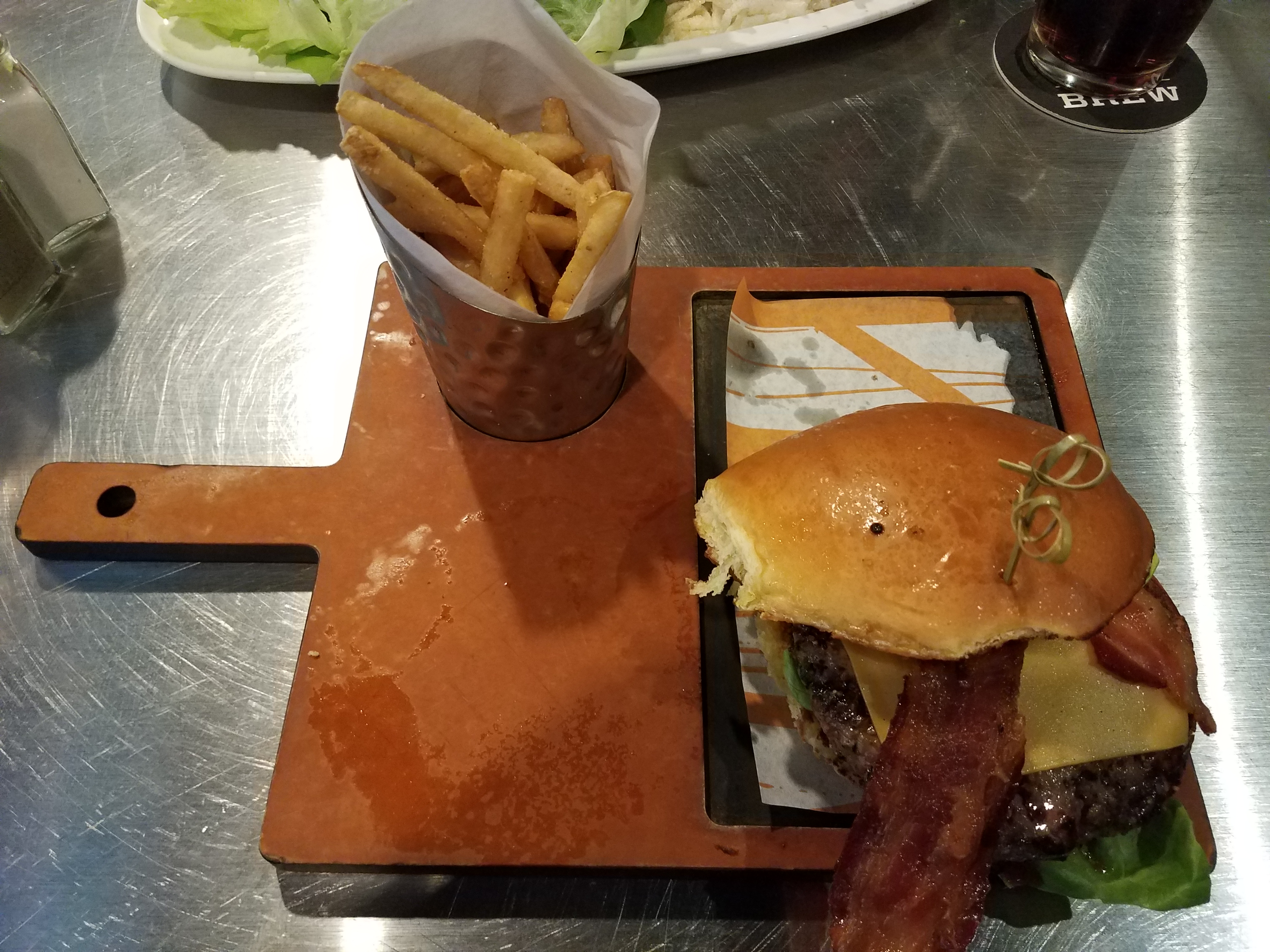 Wisconsin burger with fries at NBC Sports Grill & Brew in Universal's CityWalk - by unofficialuniversal.com.
