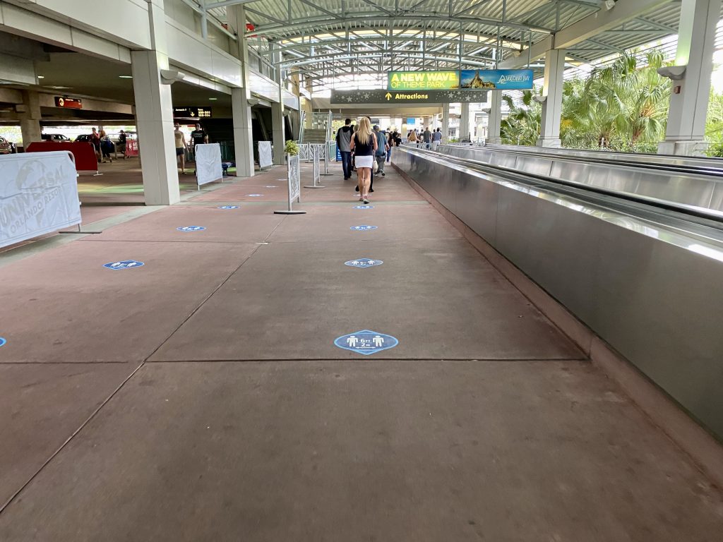 Social distancing stickers on the ground in Universal Orlando Resort's parking garage - by unofficialuniversal.com.